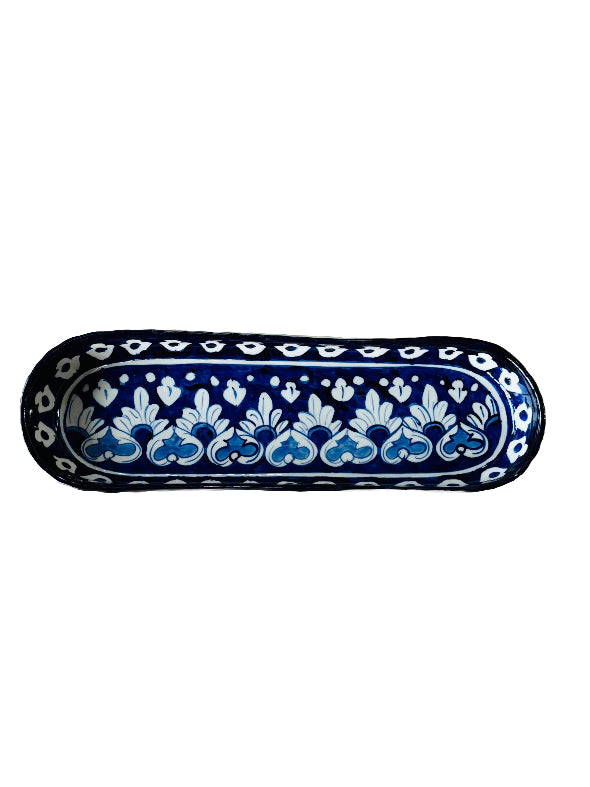 Decorative ceramic tray with blue and white floral pattern on a white background